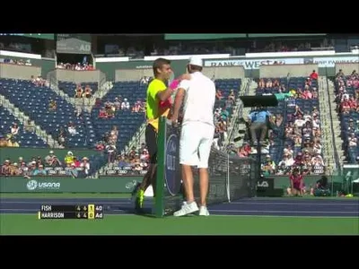 Fish falls over the net in Indian Wells against Harrison